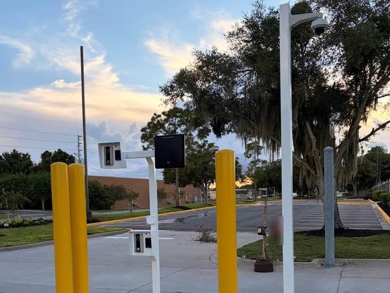 Gate entry with card readers, intercoms and a dome camera on a pole, installed by MTC Group