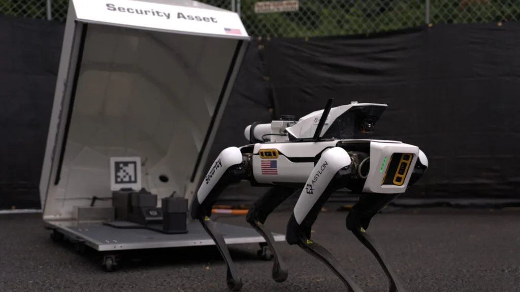 Asylon robot dog on patrol beside its DogHouse dock